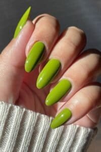 Vibrant lime green acrylic nails with glossy finish, perfect for a bold nail art look.