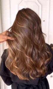Golden caramel balayage hair color, wavy hairstyle at Sasha Beauty Salon.