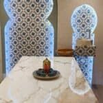 Aromatic room with traditional Moroccan decor, marble fountain, and intricate tile patterns at Sasha Beauty Salon.